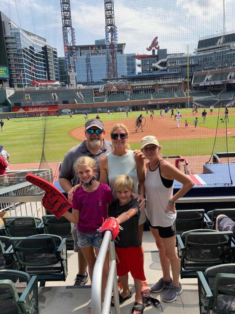 A family photo taken at a football field