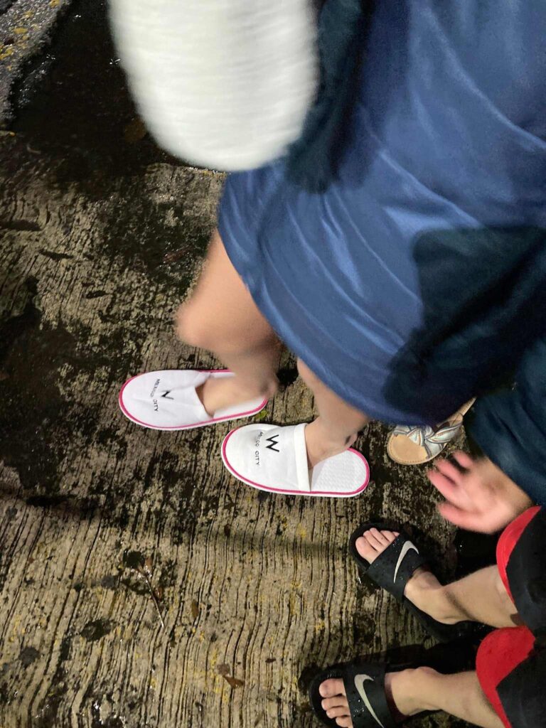 A woman wearing a hotel’s slippers