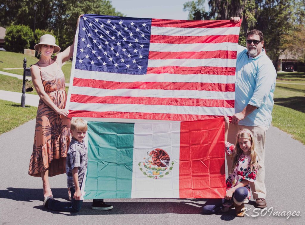 A family holding the flag of America and Mexico