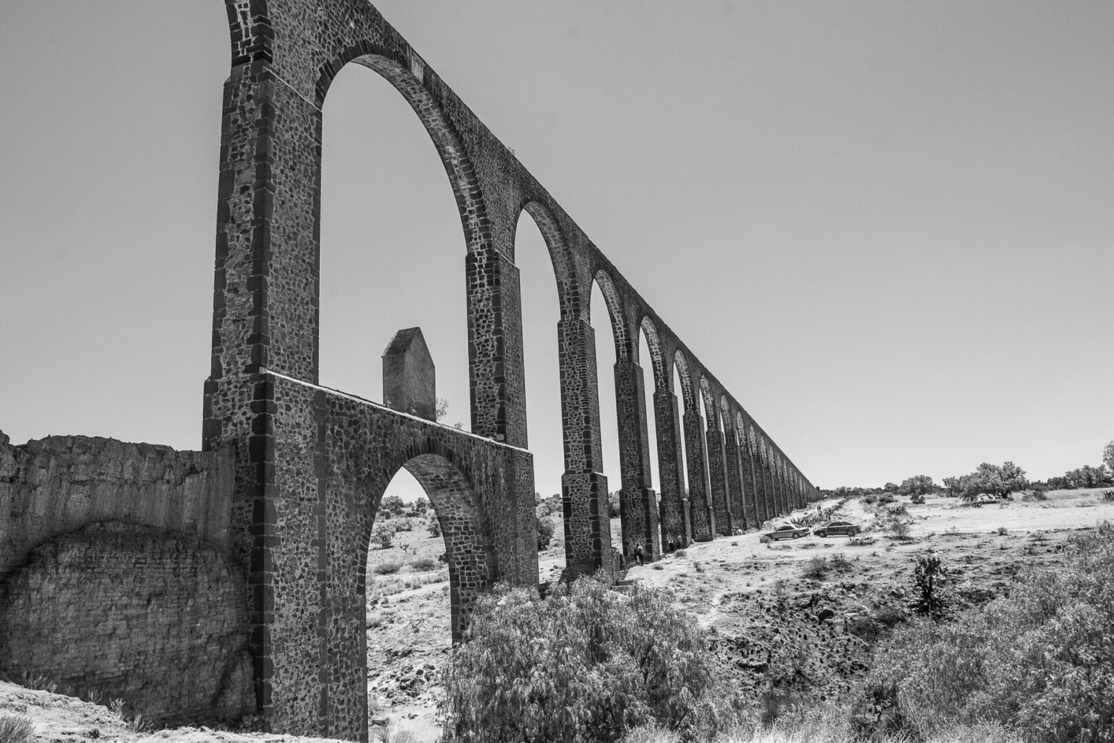 The ruins of an old structure in black and white