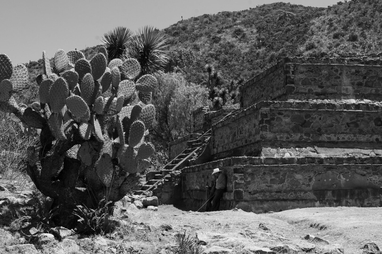 Two men resting in the shade in a desert