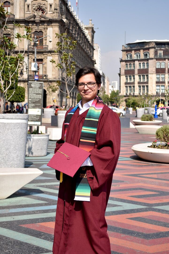 A new graduate wearing a maroon toga