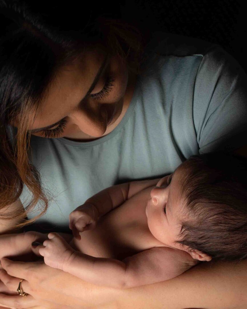 A woman holding an infant in her arms