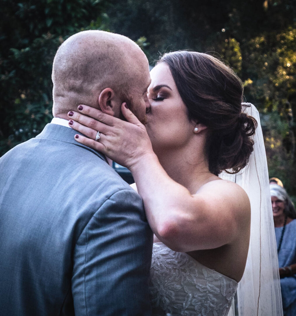 A newlywed couple kissing