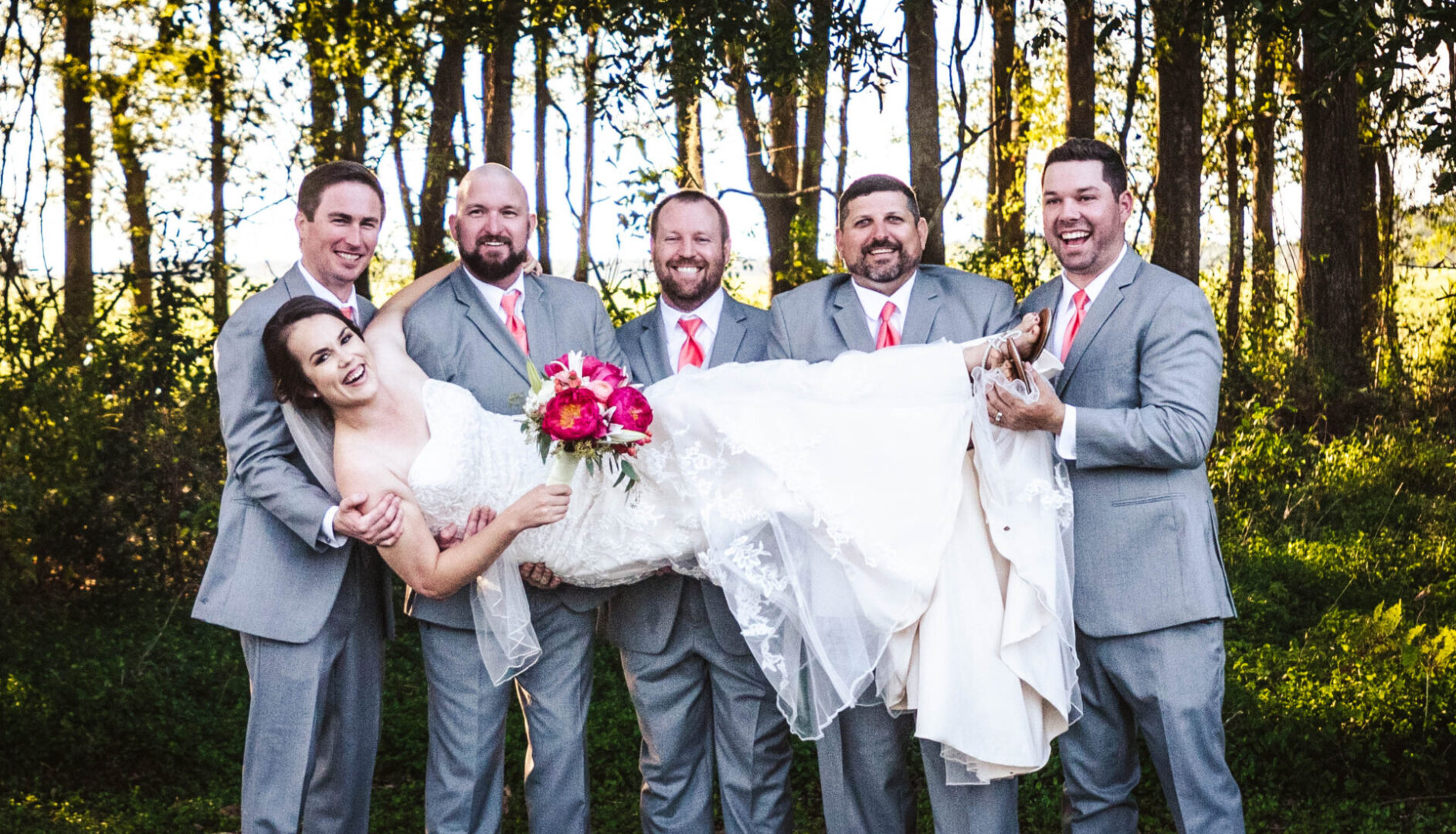 Groomsmen carrying the bride