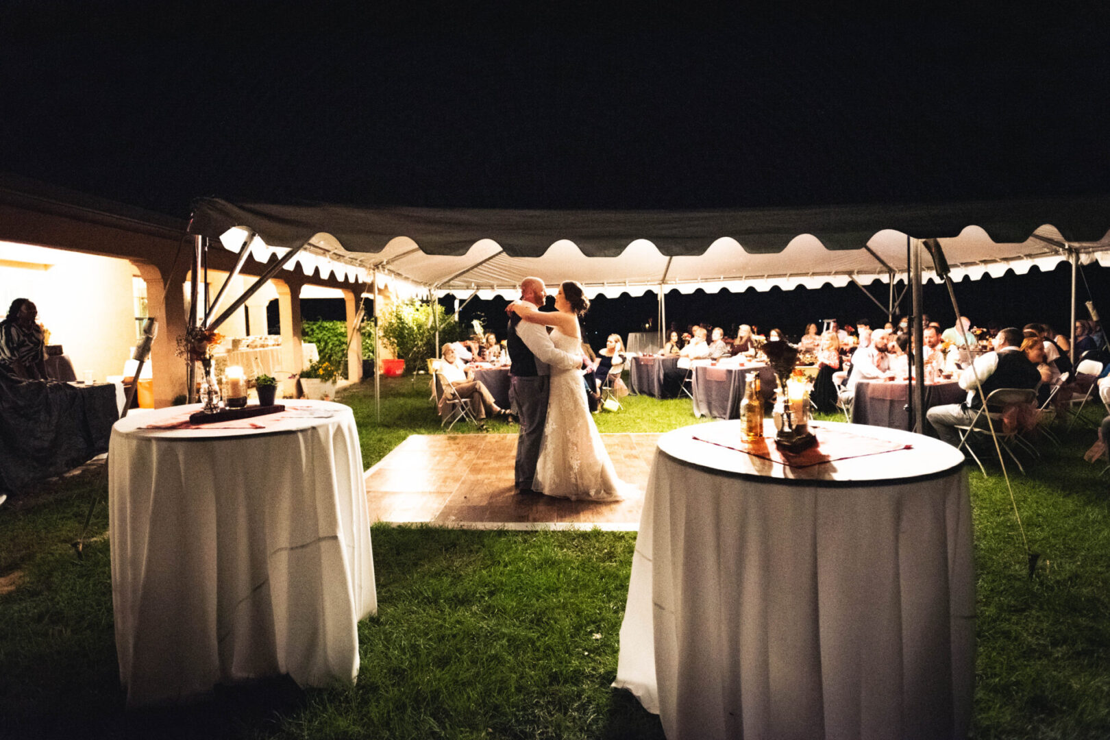 A newlywed couple dancing during the reception