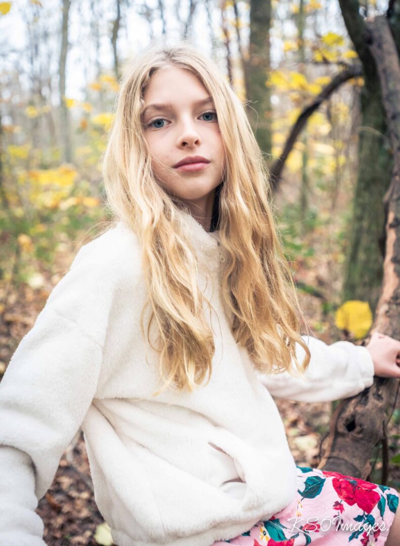 A blonde girl in a white sweater