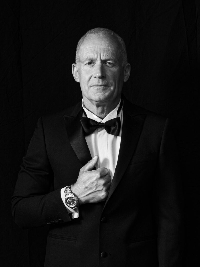 Black-and-white portrait of a man in a suit and bow tie