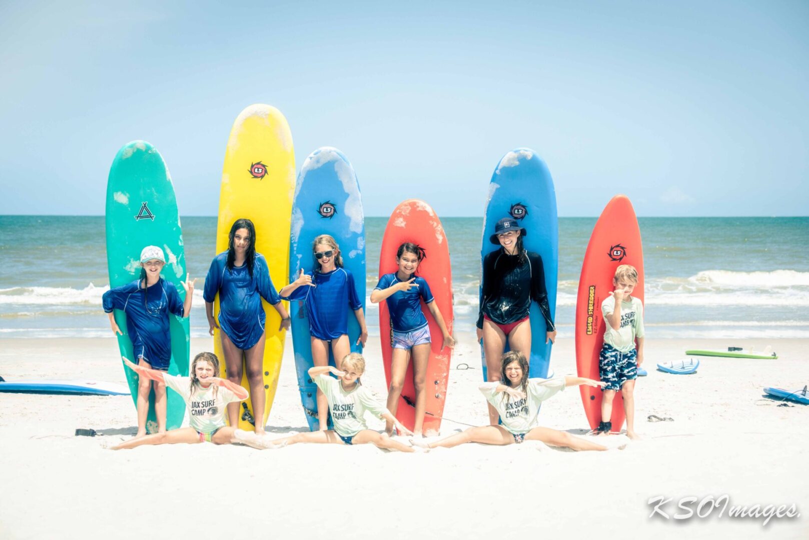 Children with surfboards on the beach