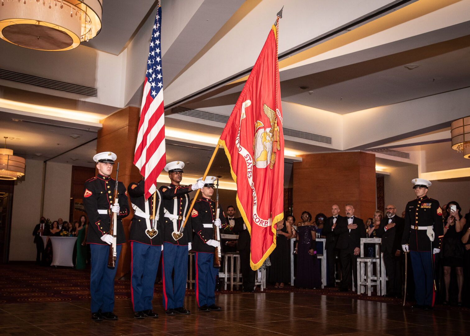 Men in uniform holding flags and standing in attention