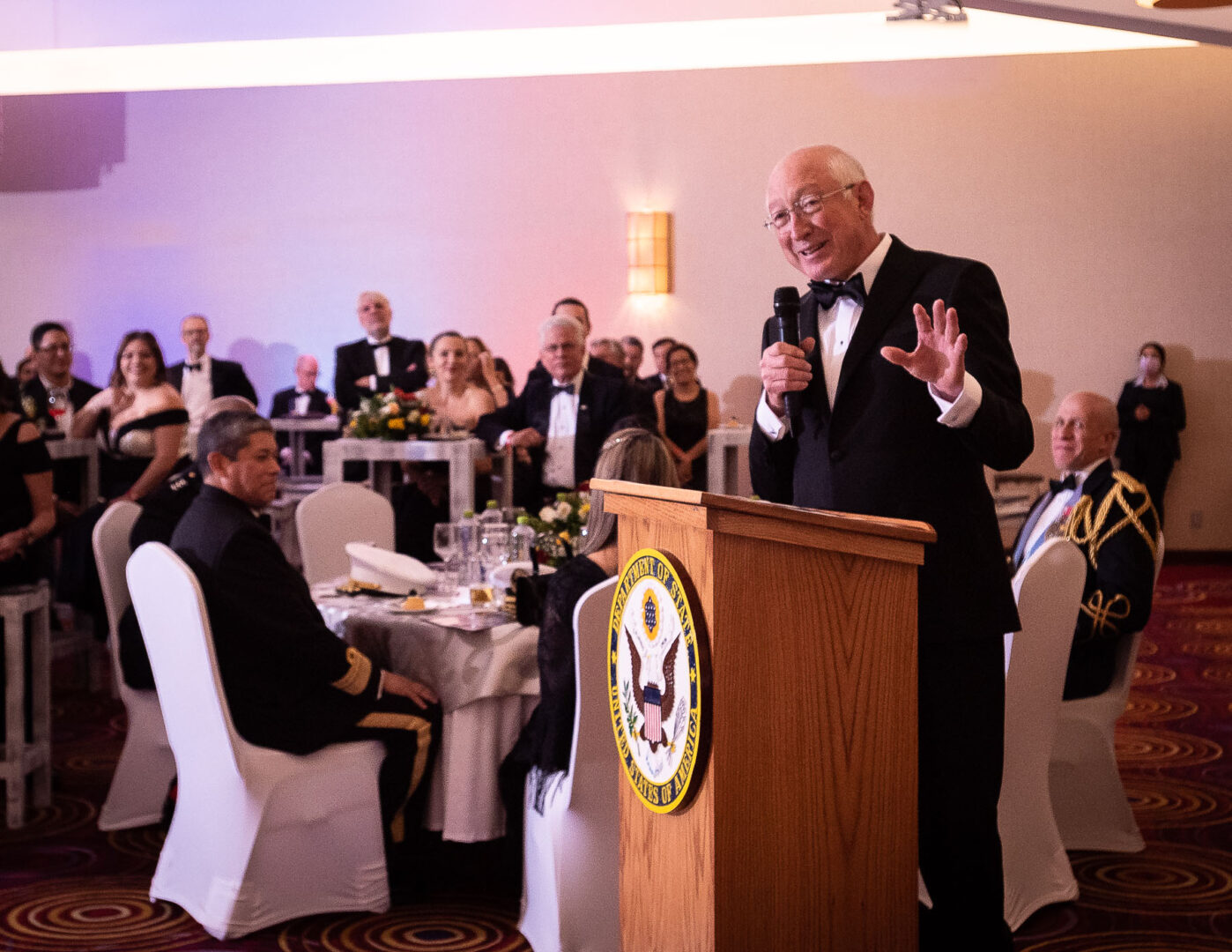 A man giving a speech behind a rostrum