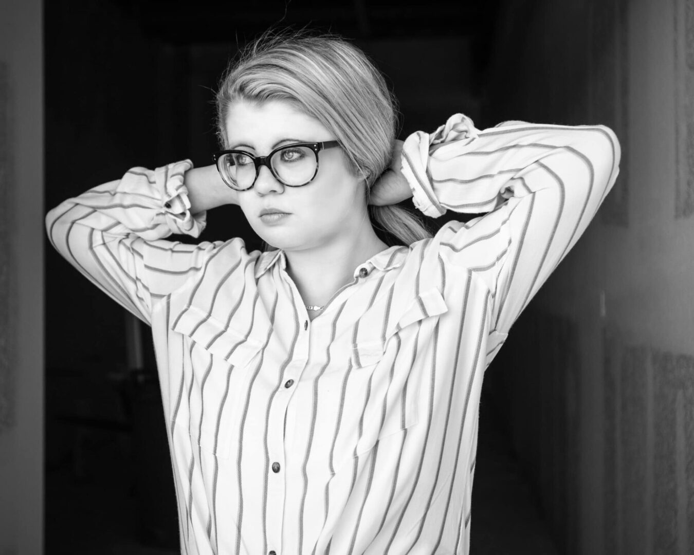 Blonde woman wearing glasses and a striped shirt